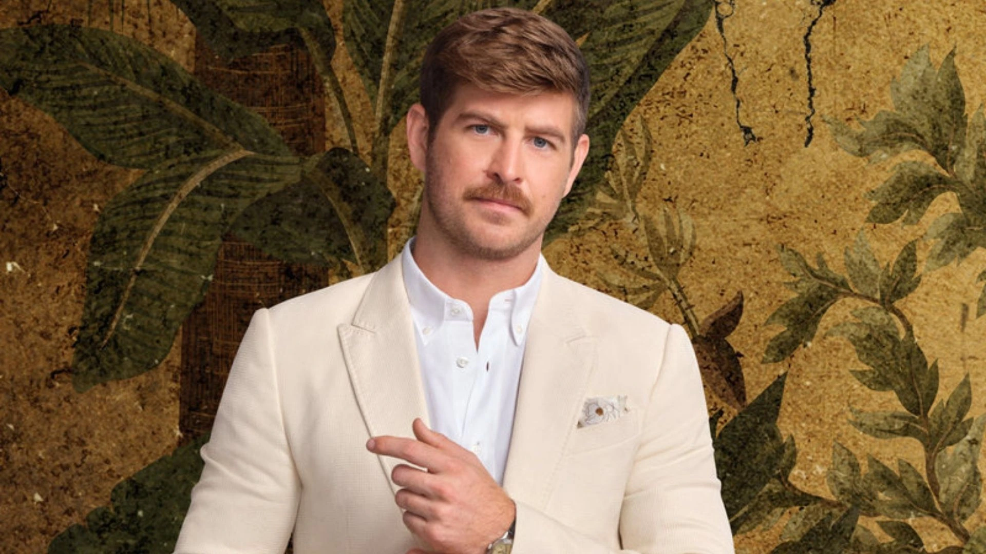 Whitney Slagsvol in a studio-style portrait wearing a cream blazer against a patterned background