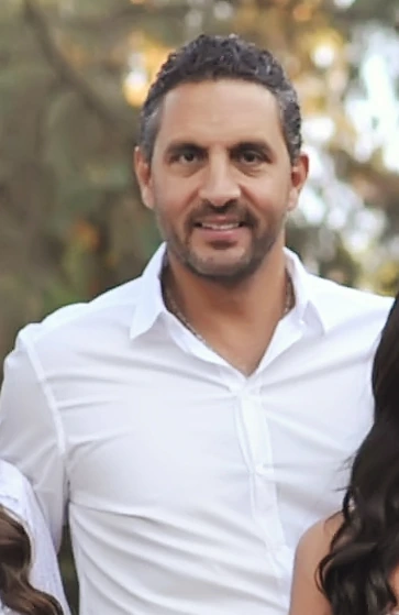 Mauricio Umansky standing outdoors in a white shirt