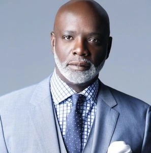 Portrait of Peter Thomas in a light suit and tie