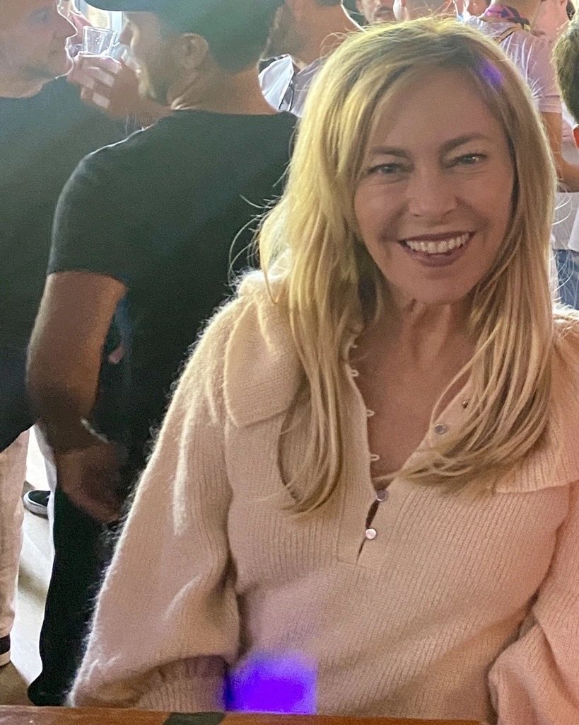 Sutton Stracke smiling at an event in a candid photo