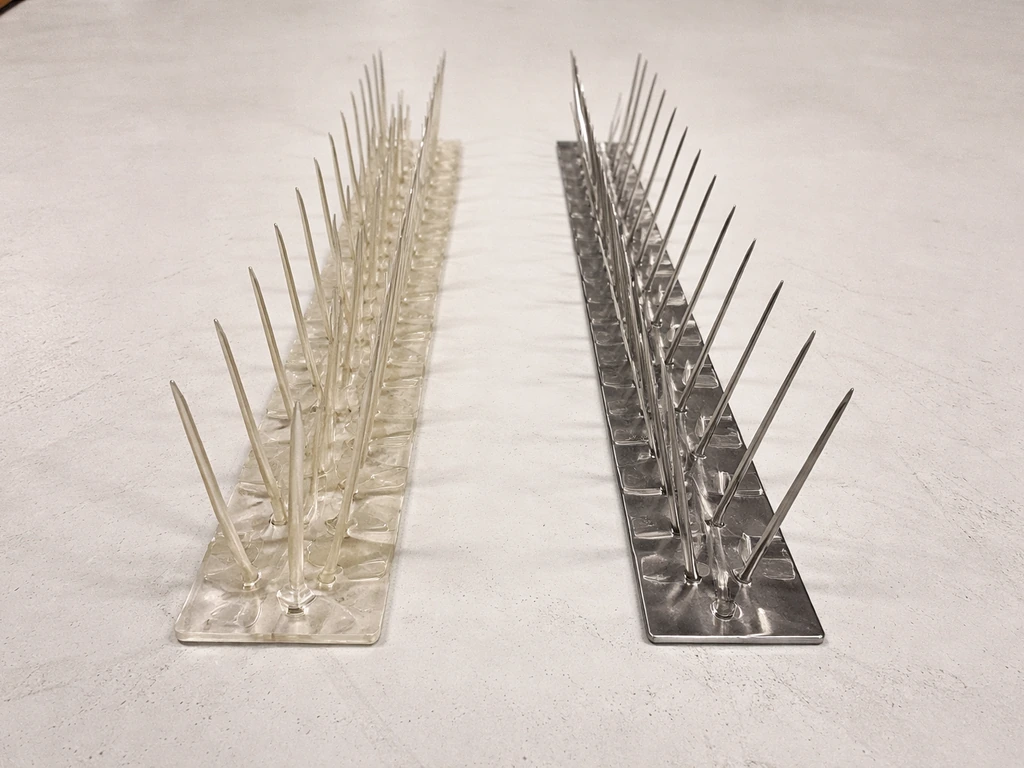 Split view of plastic and stainless-steel bird spikes showing different wear and material finish