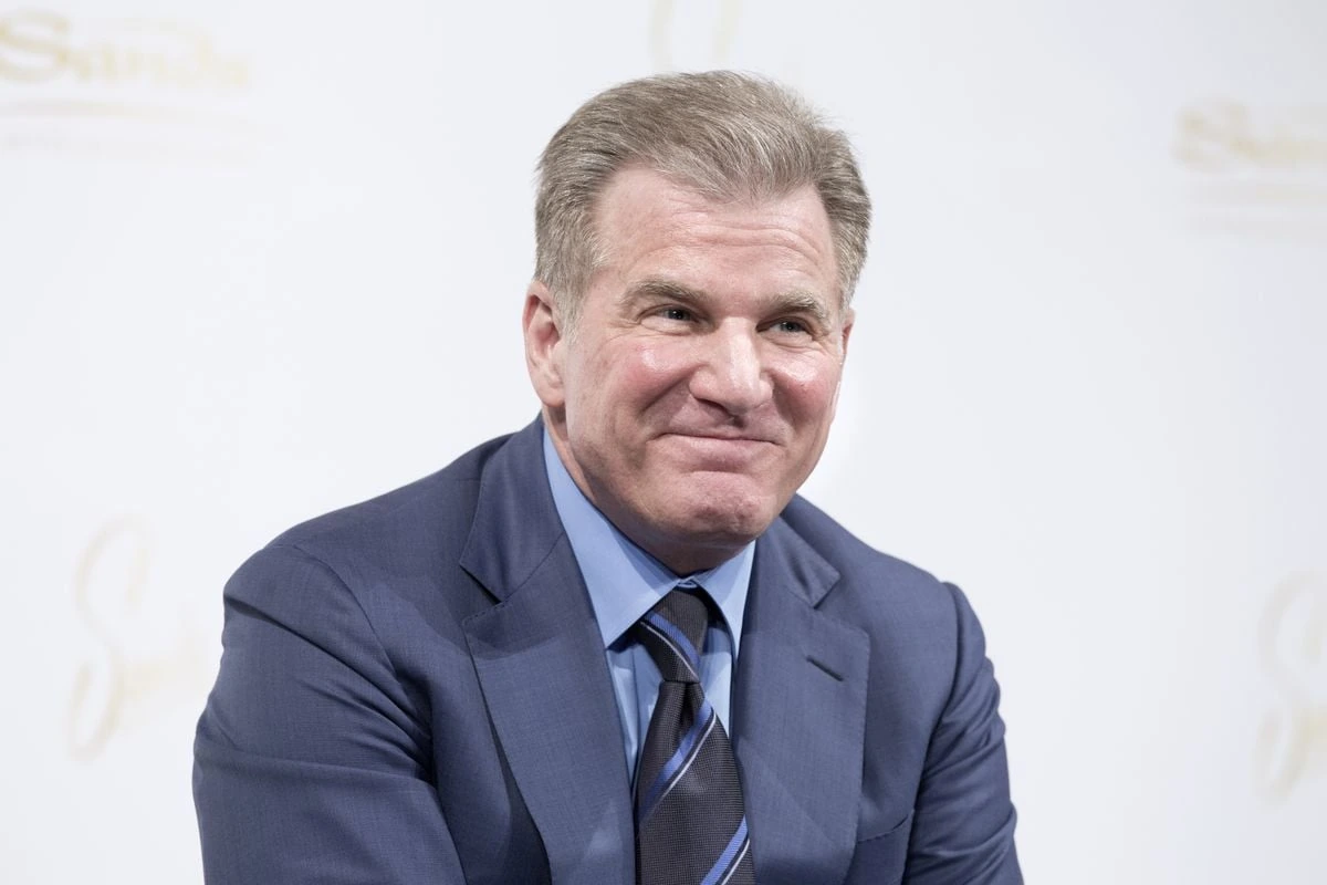 Robert G. Goldstein, Chairman and CEO of Las Vegas Sands, in a formal portrait-style photo wearing a blue suit and tie.