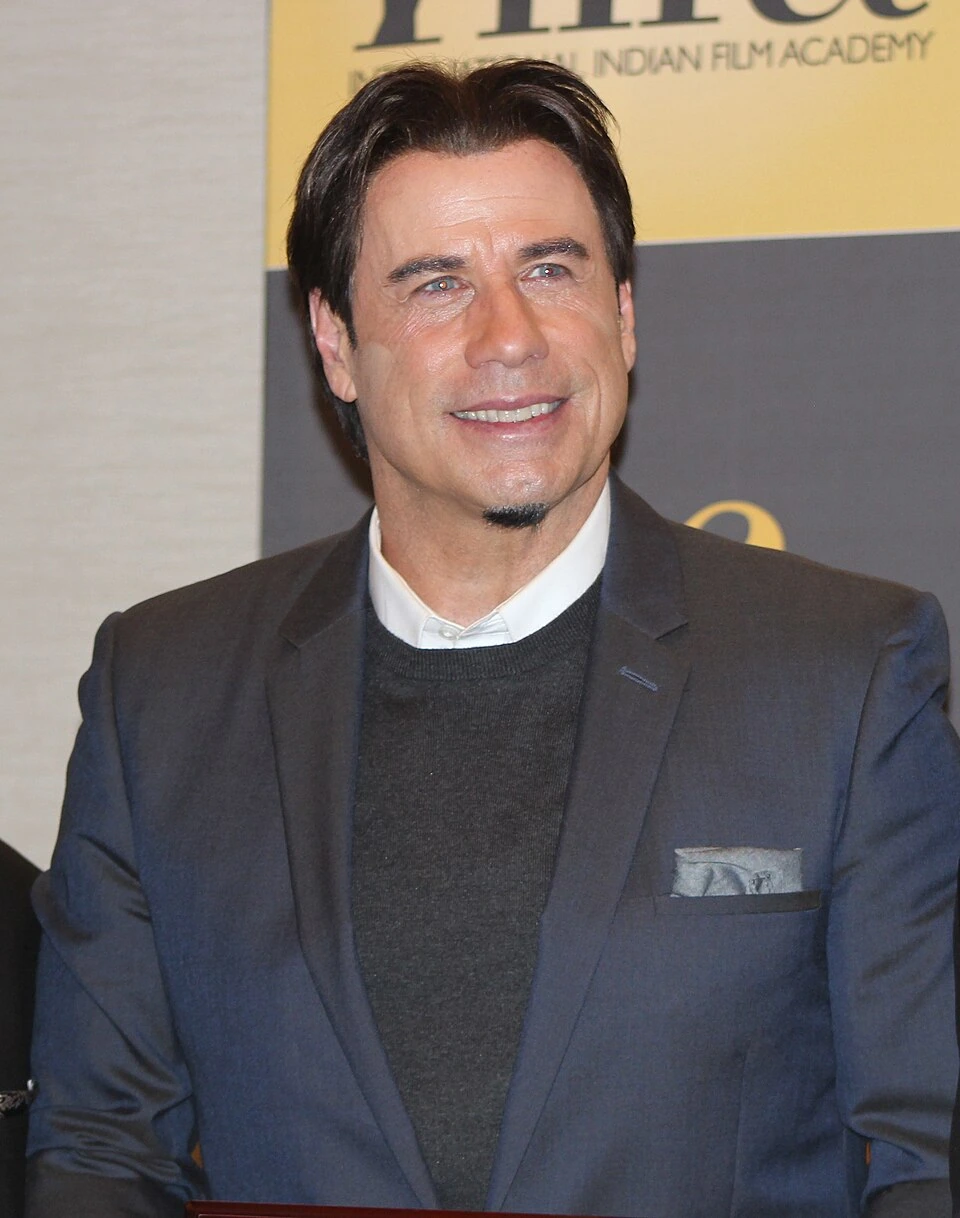 John Travolta at an event in a dark suit