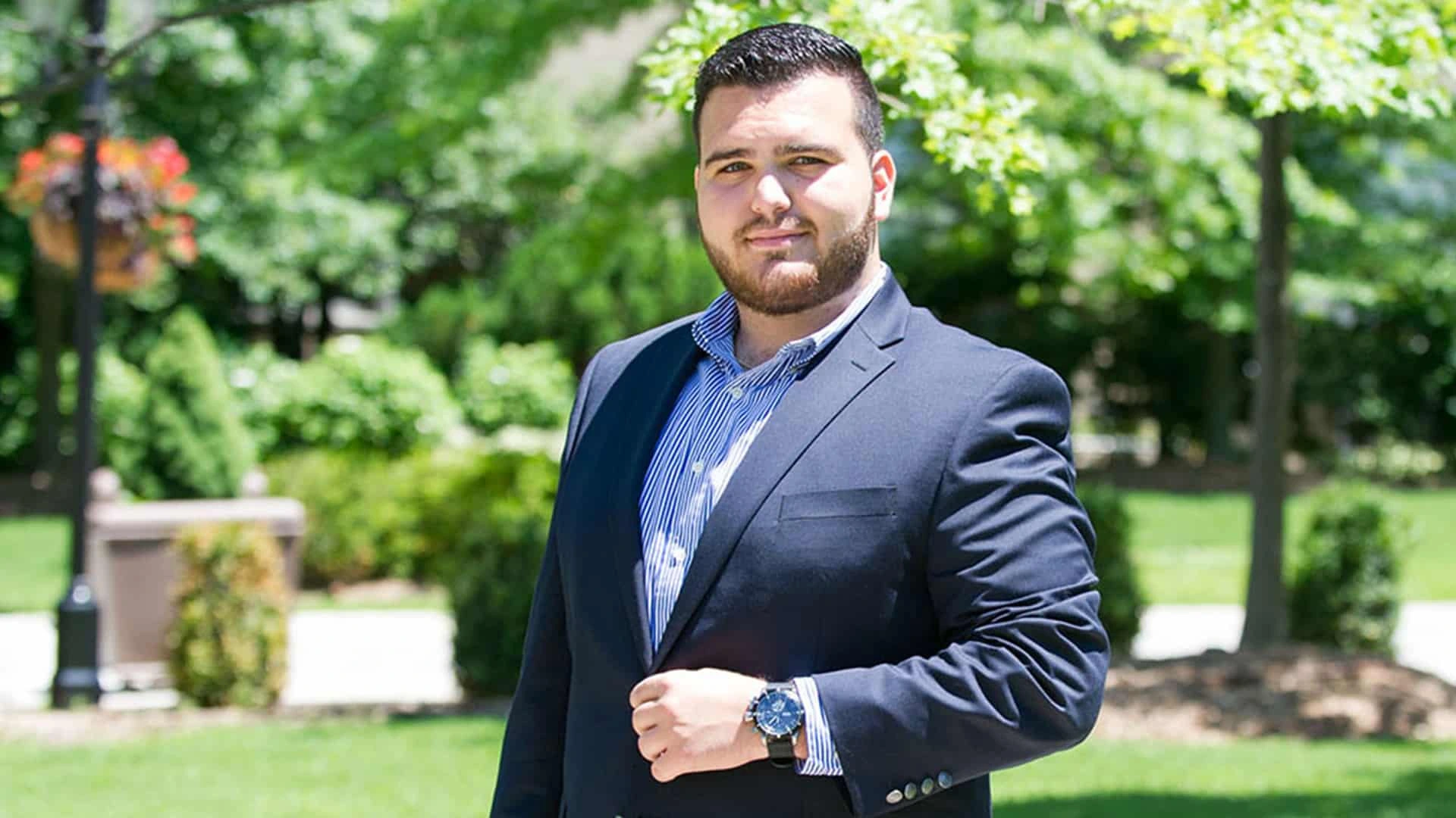 Sal Valentinetti posing outdoors in a suit and blue shirt