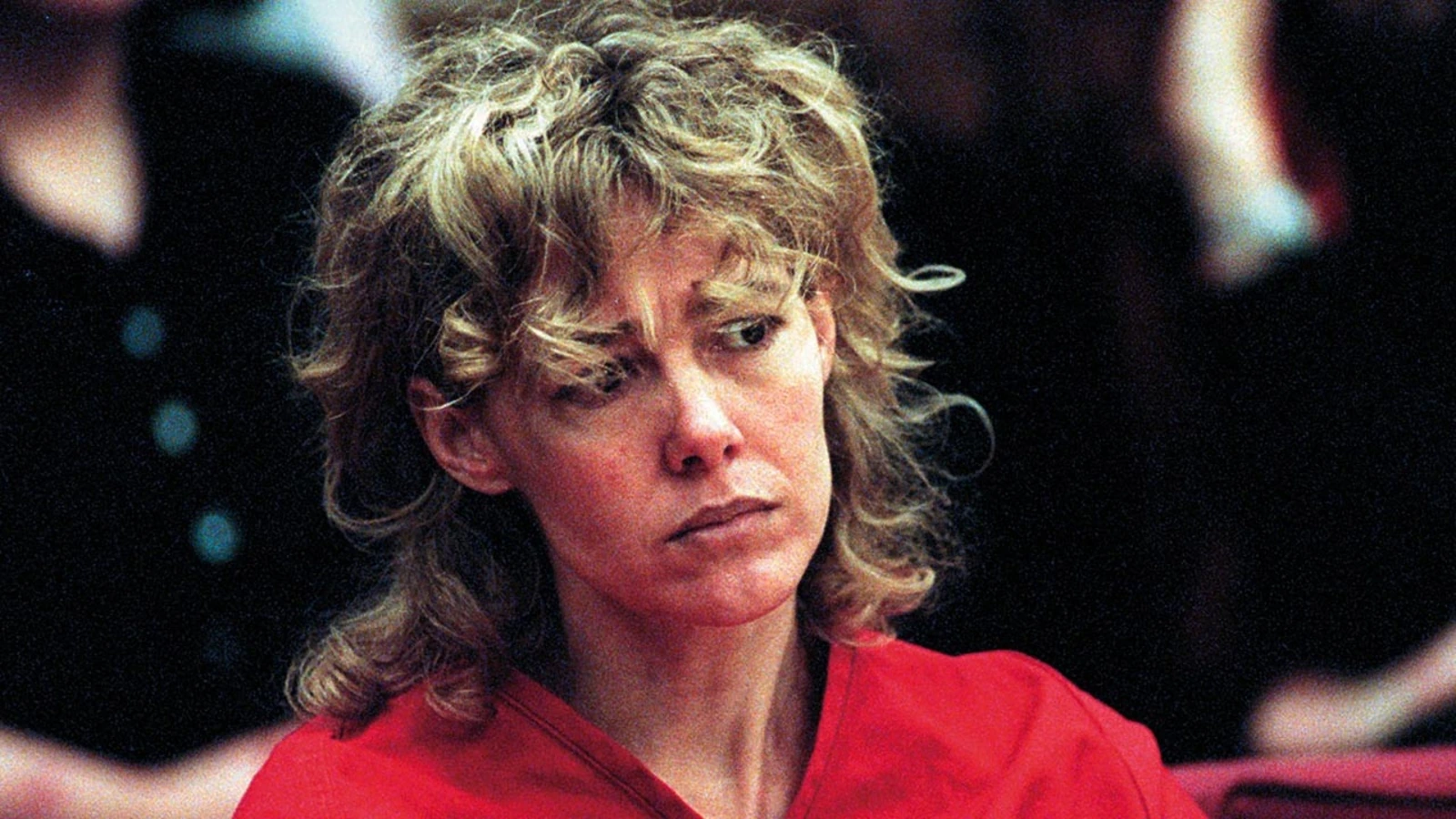 Mary Kay Letourneau in a courtroom or police-related setting, wearing a red top