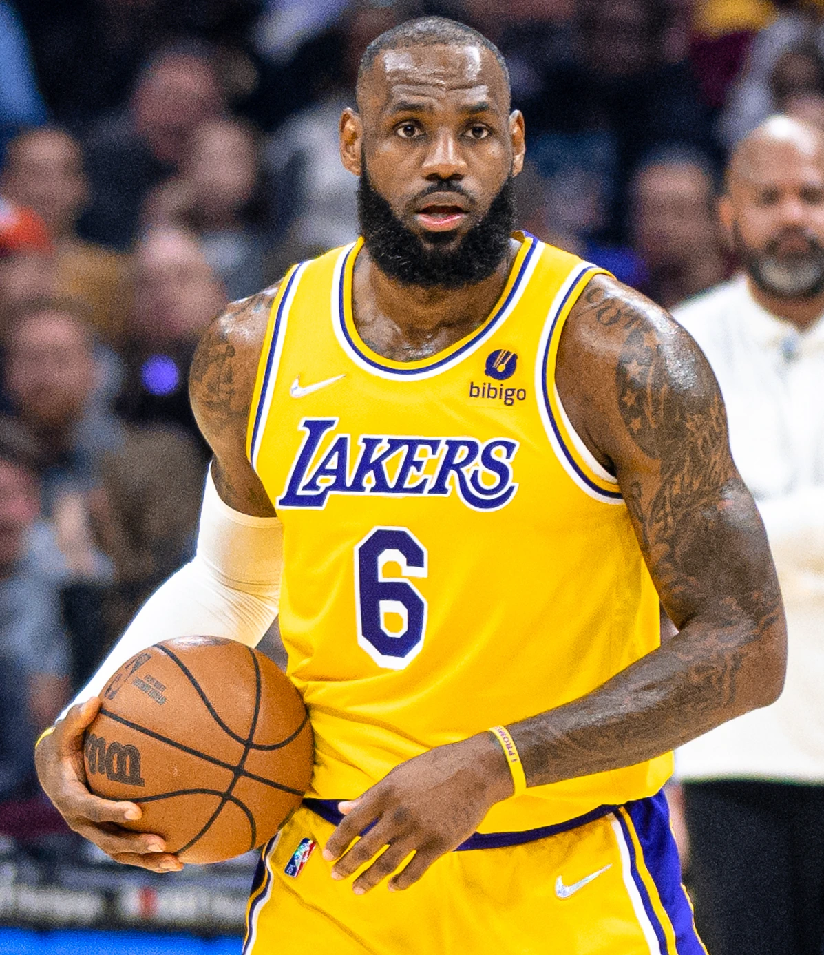 LeBron James in a Los Angeles Lakers uniform holding a basketball during a game
