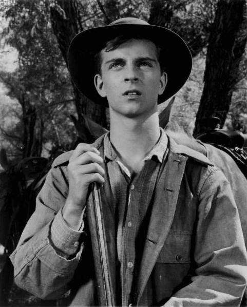 Black-and-white photo of Tommy Rettig in a cowboy hat holding a rifle, from Death Valley Days (1962).