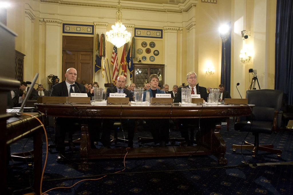 Paul Rieckhoff speaking at a congressional hearing in a formal indoor setting.