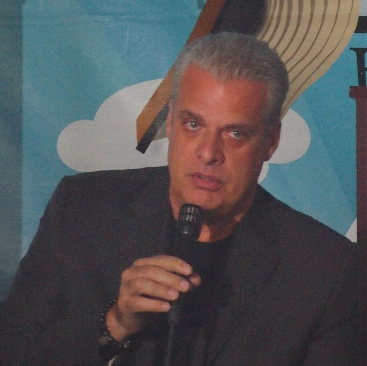 Éric Ripert speaking into a microphone at an event