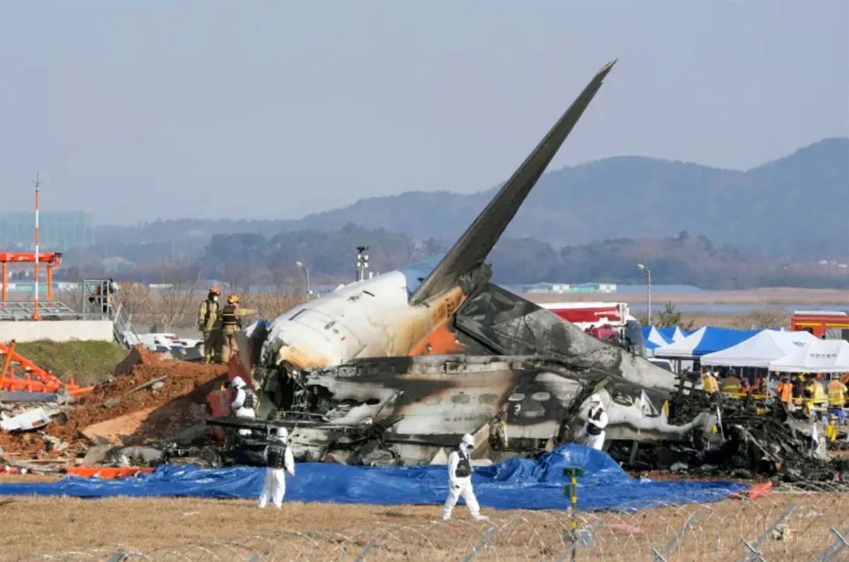 Wreckage of Jeju Air Flight 2216 Boeing 737-800 after the Muan crash, with responders at the scene