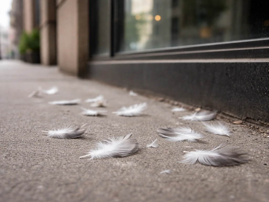 Scattered bird feathers on the sidewalk beside a building window after a collision