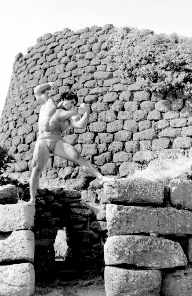 Franco Columbu posing outdoors in the 1970s, black-and-white photo