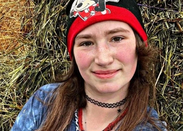 Bird Brown from Alaskan Bush People posing outdoors in a red hat