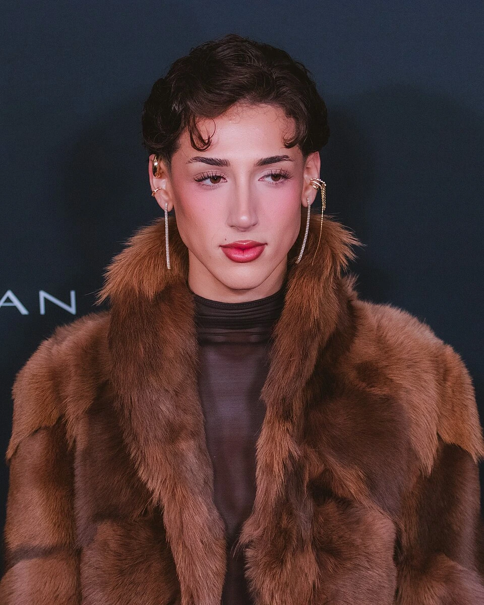 Portrait photo of Meredith Duxbury at an event wearing a brown fur coat against a dark background.