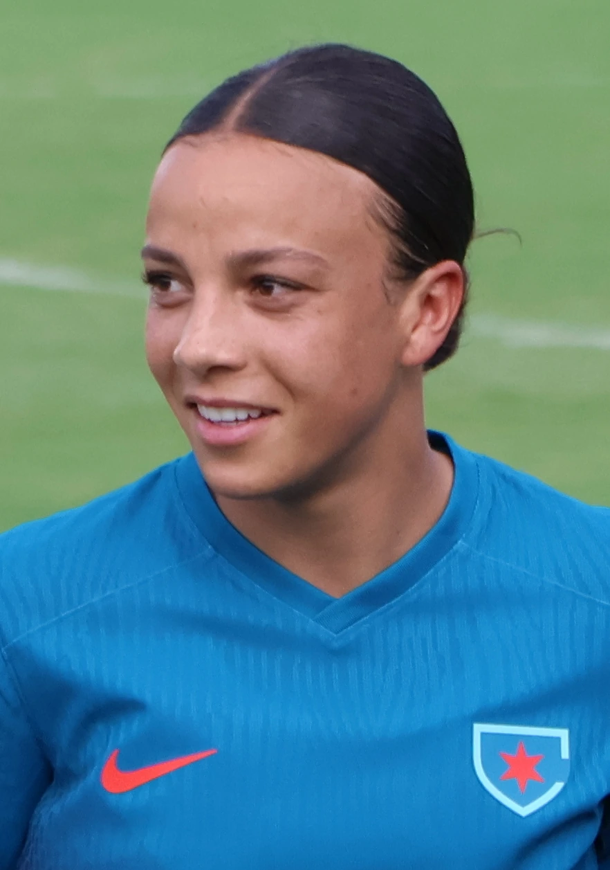 Mallory Swanson in a blue soccer jersey on the field