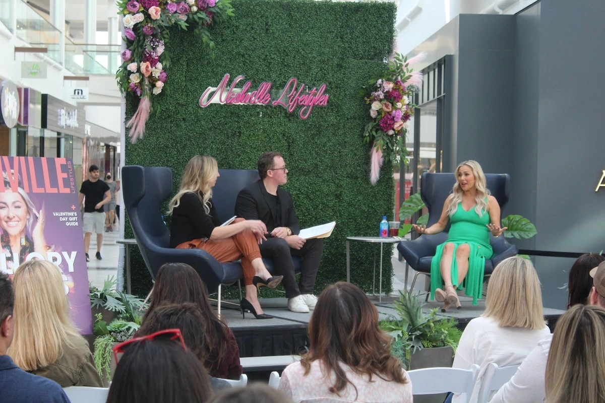Mallory Ervin speaking onstage during a live interview event