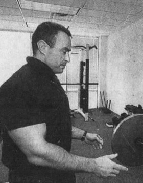Charles Poliquin in a gym, side profile