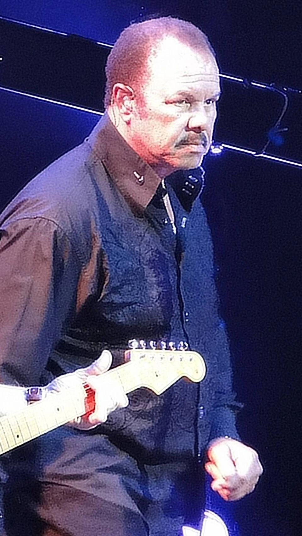 Sonny Charles performing on stage with a guitar