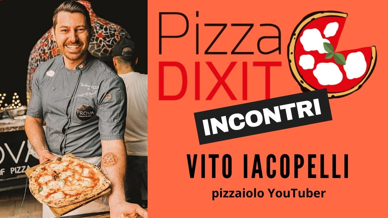 Vito Iacopelli smiling and holding a pizza at an outdoor event