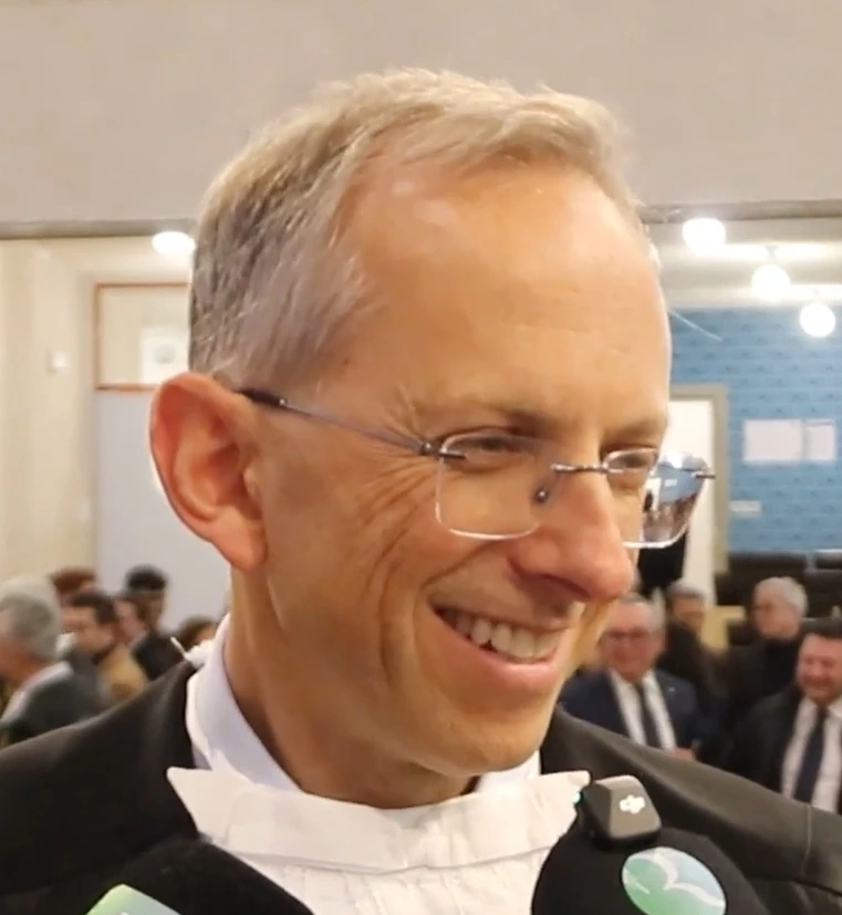 Benedetto Vigna speaking to reporters