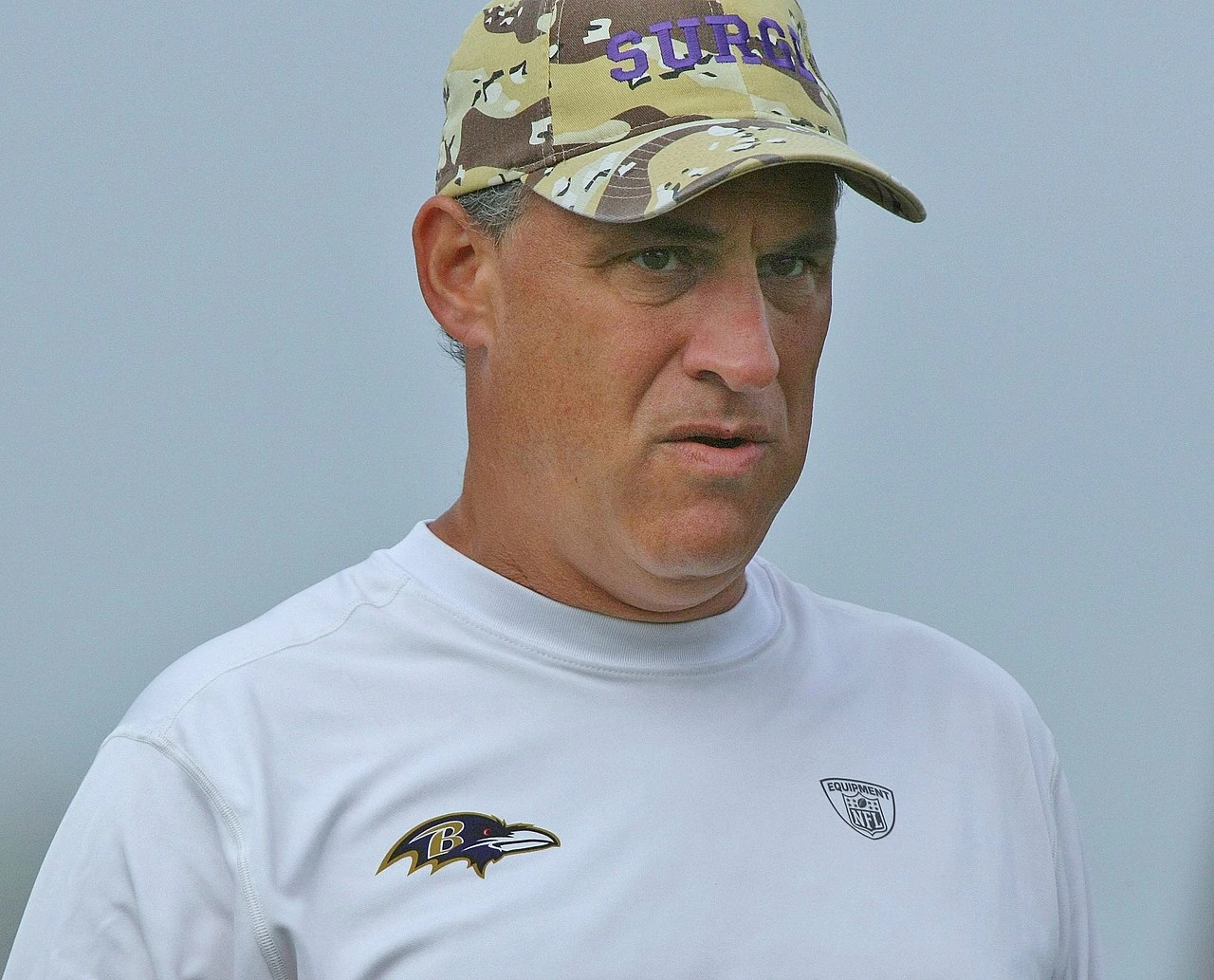 Vic Fangio in 2009, wearing a camouflage cap and white shirt