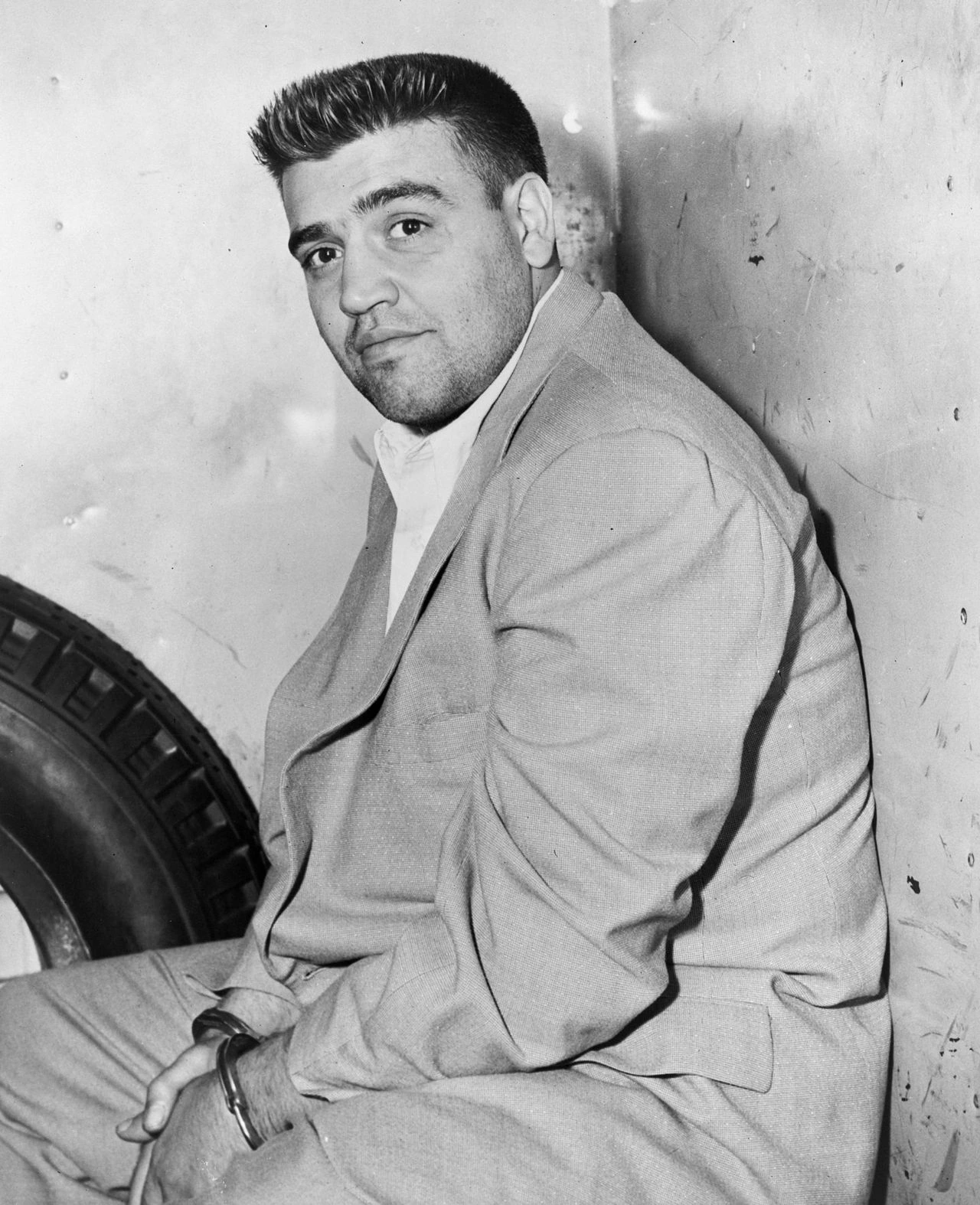 Black-and-white portrait of Vincent Gigante seated against a wall