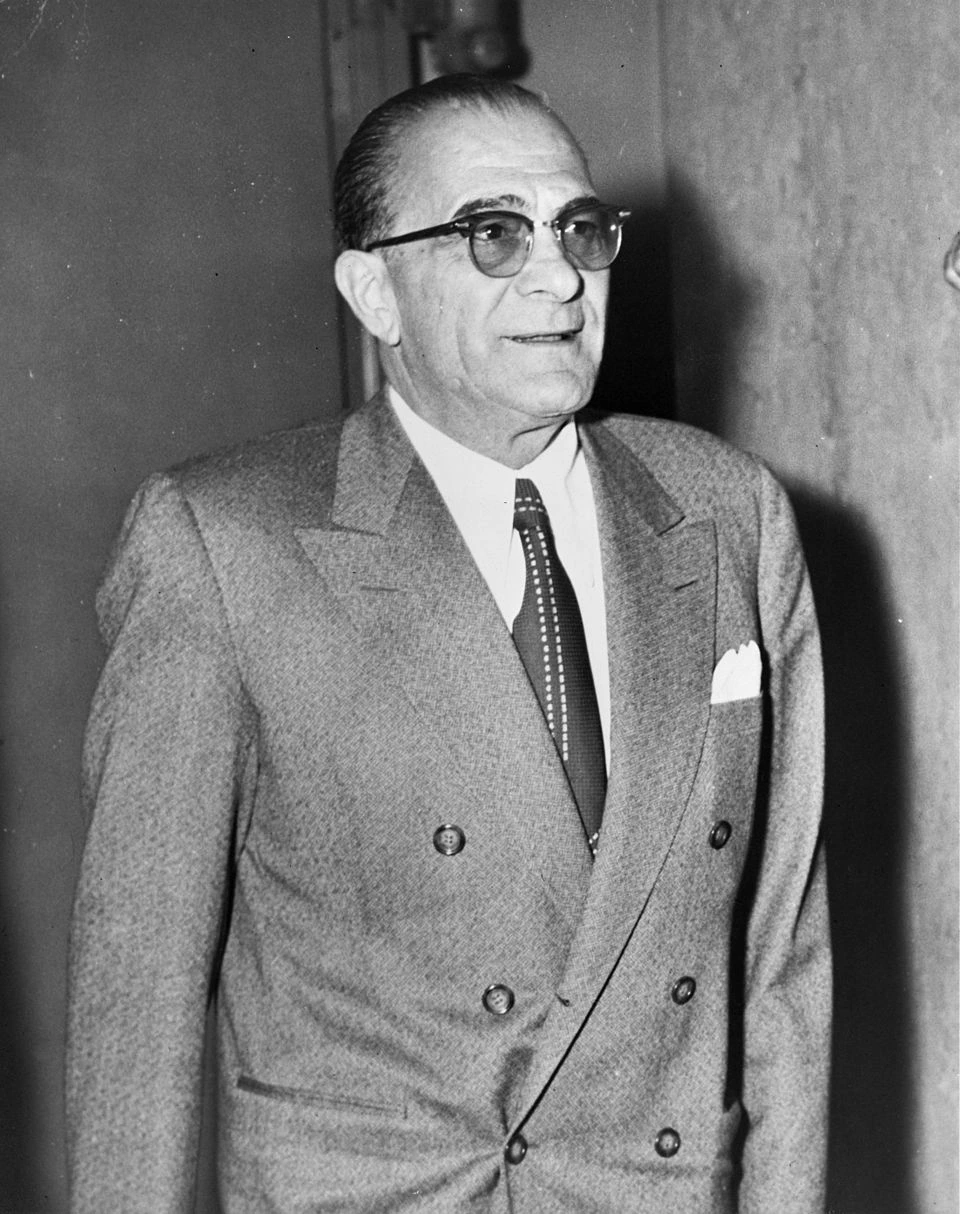Black-and-white portrait photo of Vito Genovese in a suit and glasses.