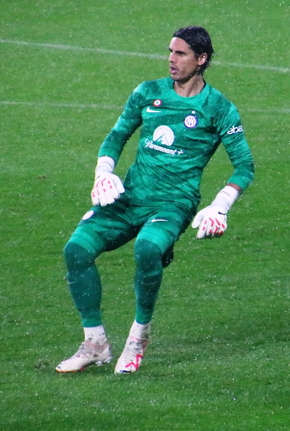 Yann Sommer in a green Inter Milan goalkeeper kit on the pitch during a match.