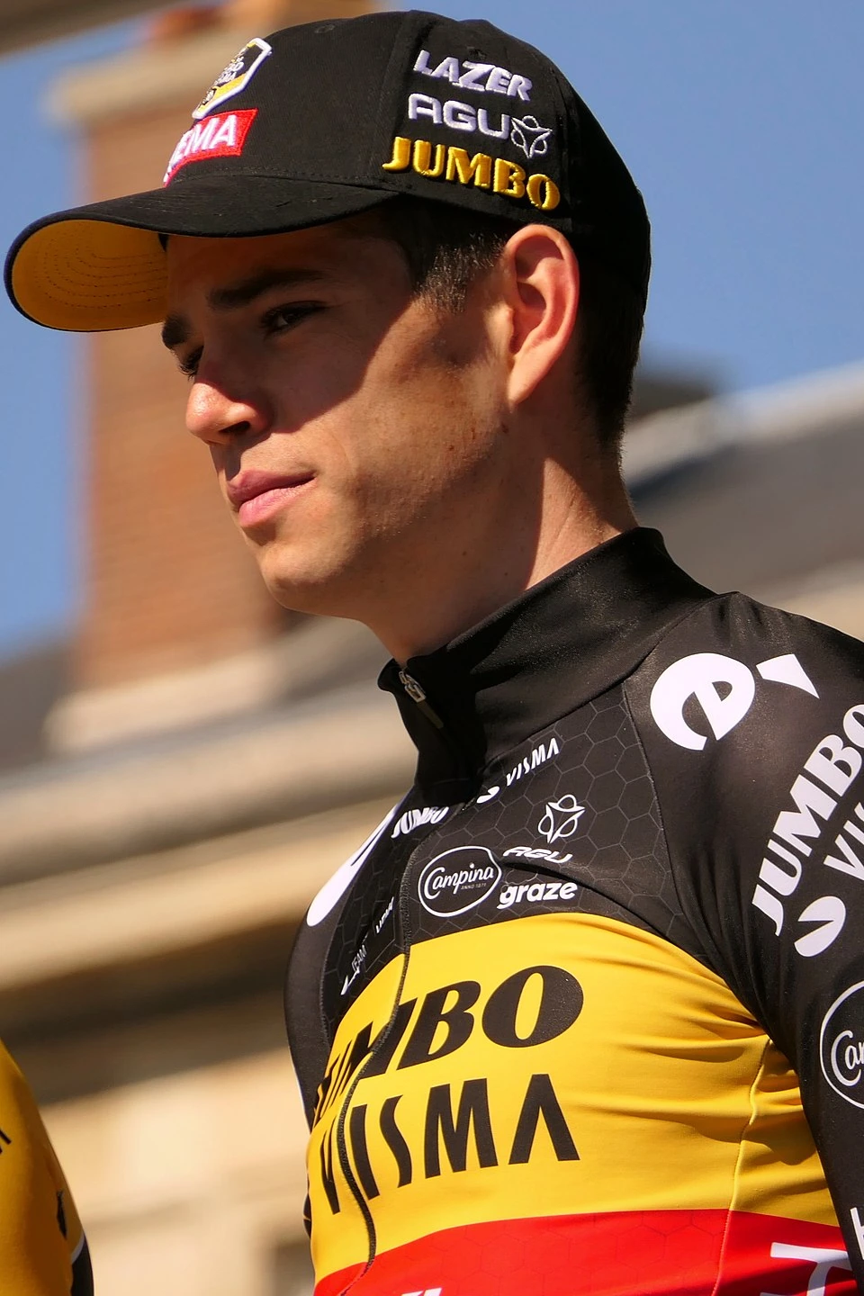 Portrait of Wout van Aert in a Jumbo-Visma cycling cap and jersey.