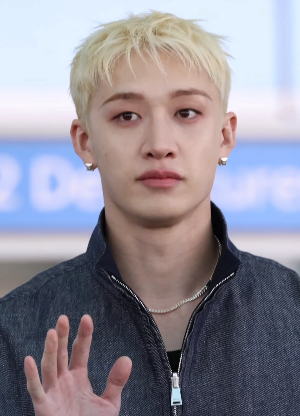 Close-up real photo of Bang Chan of Stray Kids at an event, facing the camera.