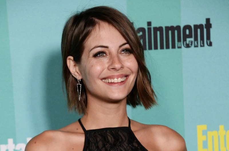 Willa Holland at a public event, smiling in a close-up editorial-style photo.