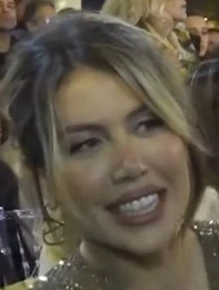 Wanda Nara at an event, smiling in a candid close-up