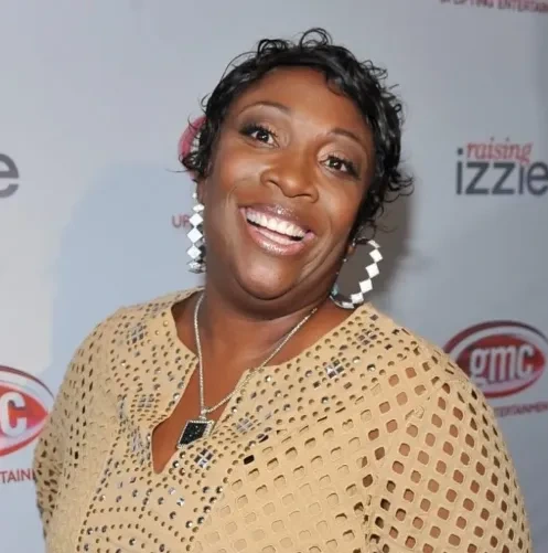 Wanda Smith smiling at an event backdrop
