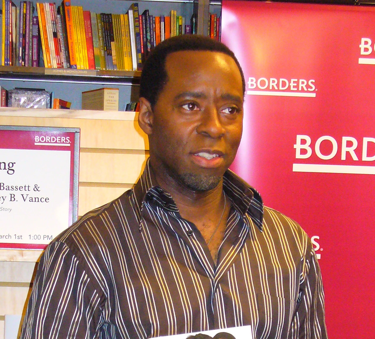 Courtney B. Vance at a public event, standing in front of a Borders backdrop