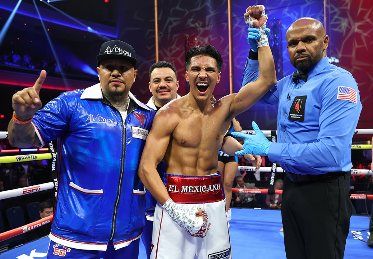 Emiliano Vargas celebrating in the boxing ring with his team after a match