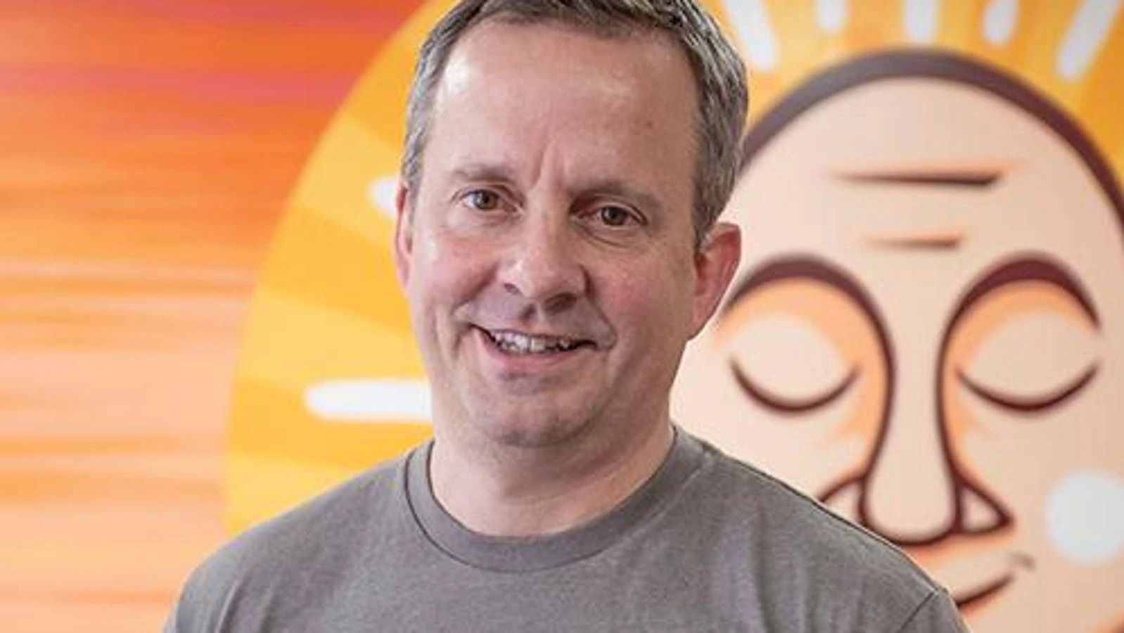 Charles Coristine, founder of LesserEvil, smiling in front of a branded background