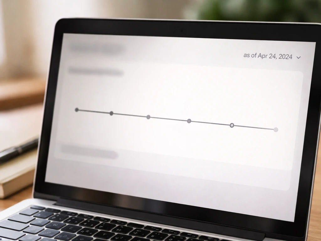 Close-up of laptop screen showing a wealth-history timeline with a visible “as of” date