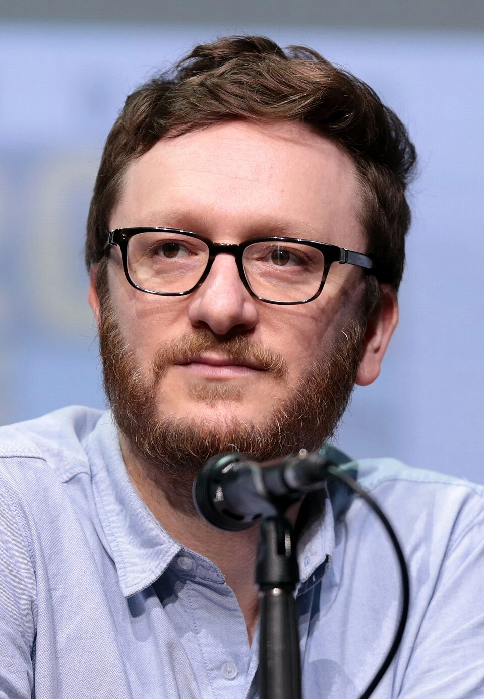 Akiva Schaffer speaking at a microphone during a panel appearance