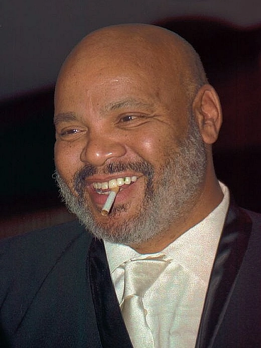 James Avery smiling in a tuxedo with a cigar in his mouth