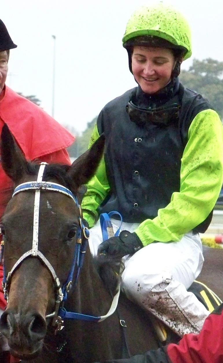 Michelle J. Payne riding Yosei in racing silks and helmet