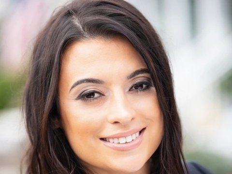 Headshot of Michelle Pais smiling against a softly blurred background