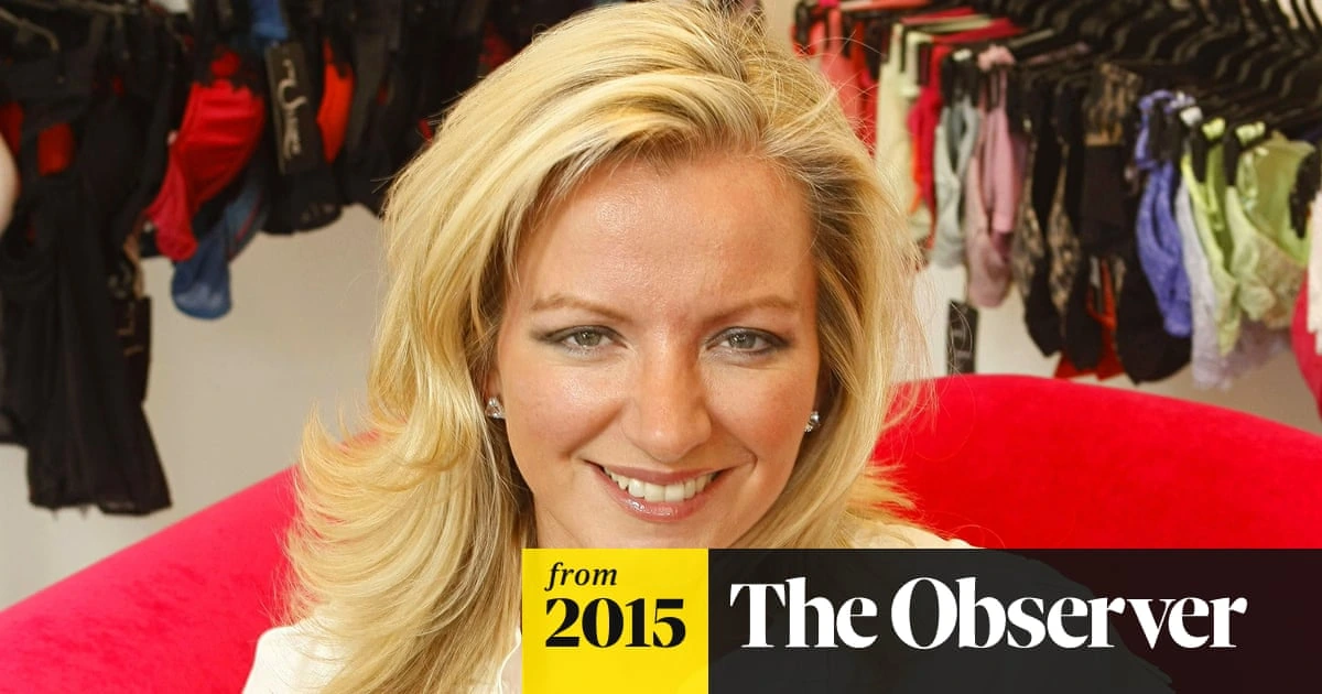 Michelle Mone smiling in a documentary-style portrait with lingerie in the background