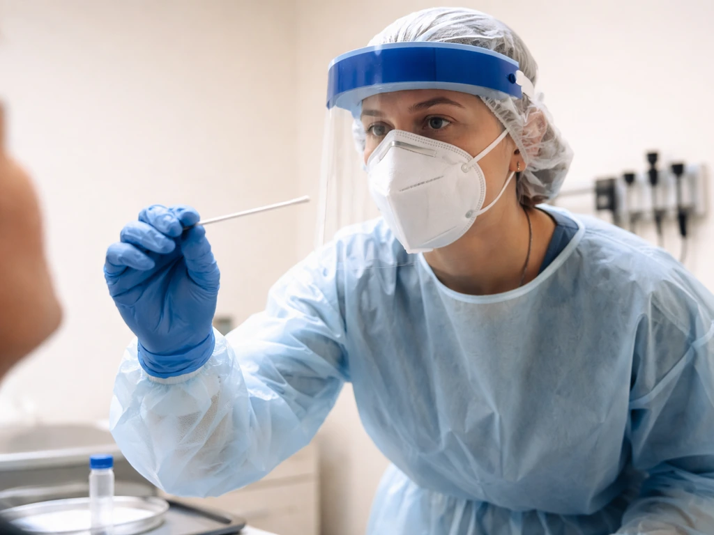 Clinician in PPE collecting a nasopharyngeal swab sample in a quiet exam room for suspected bird flu.