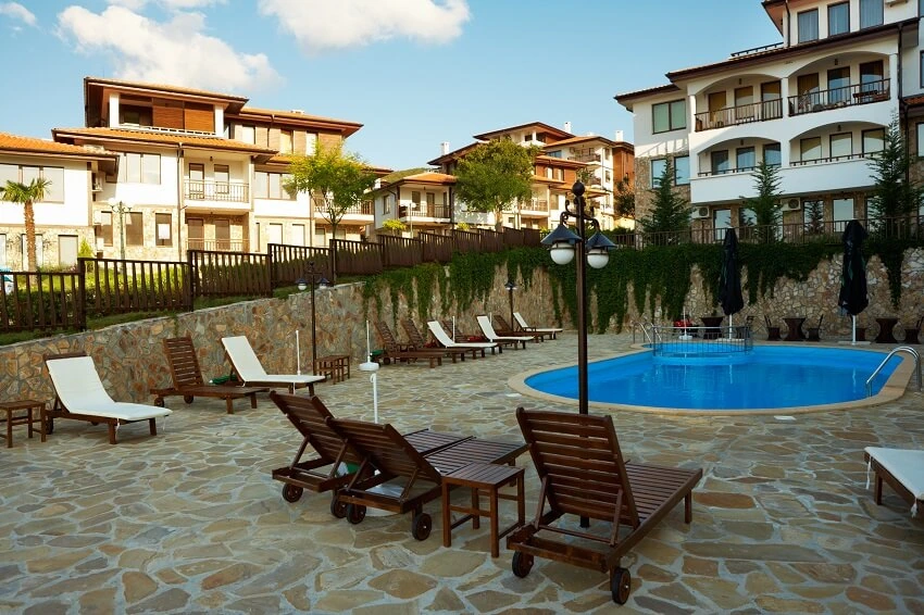 A real photo of a flagstone patio around a pool, showing the stone surface in an outdoor setting.