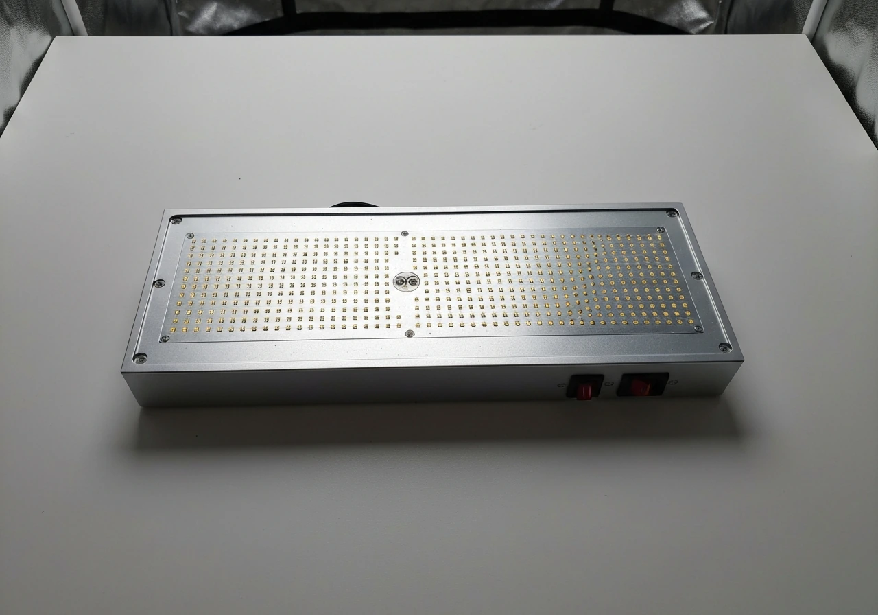 Overhead close-up of a rectangular panel LED grow light showing the LED array and dual switches