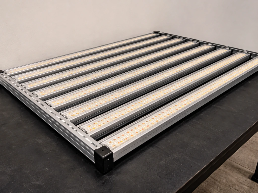 Close-up of a bar-light fixture showing multiple LED strips mounted across an aluminum frame.