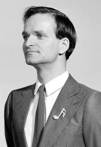 Black-and-white portrait of Florian Schneider-Esleben in a suit and tie