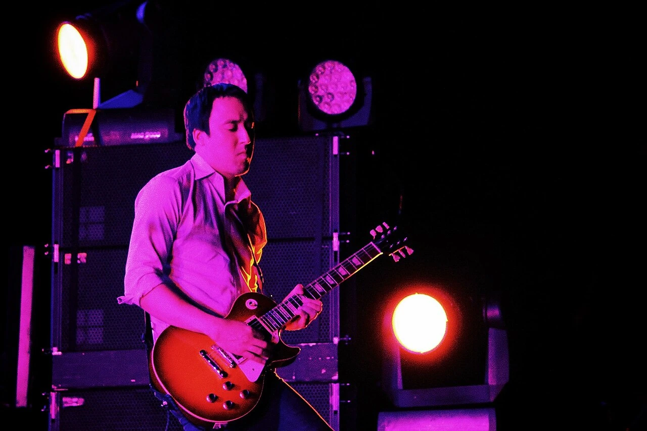 Jeff Schroeder performing onstage with a guitar