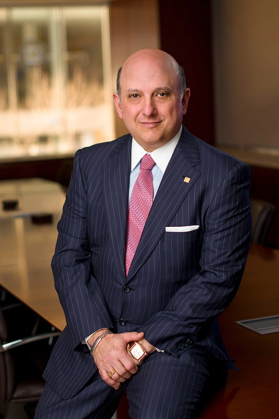 Nicholas Schorsch in a suit posing indoors.