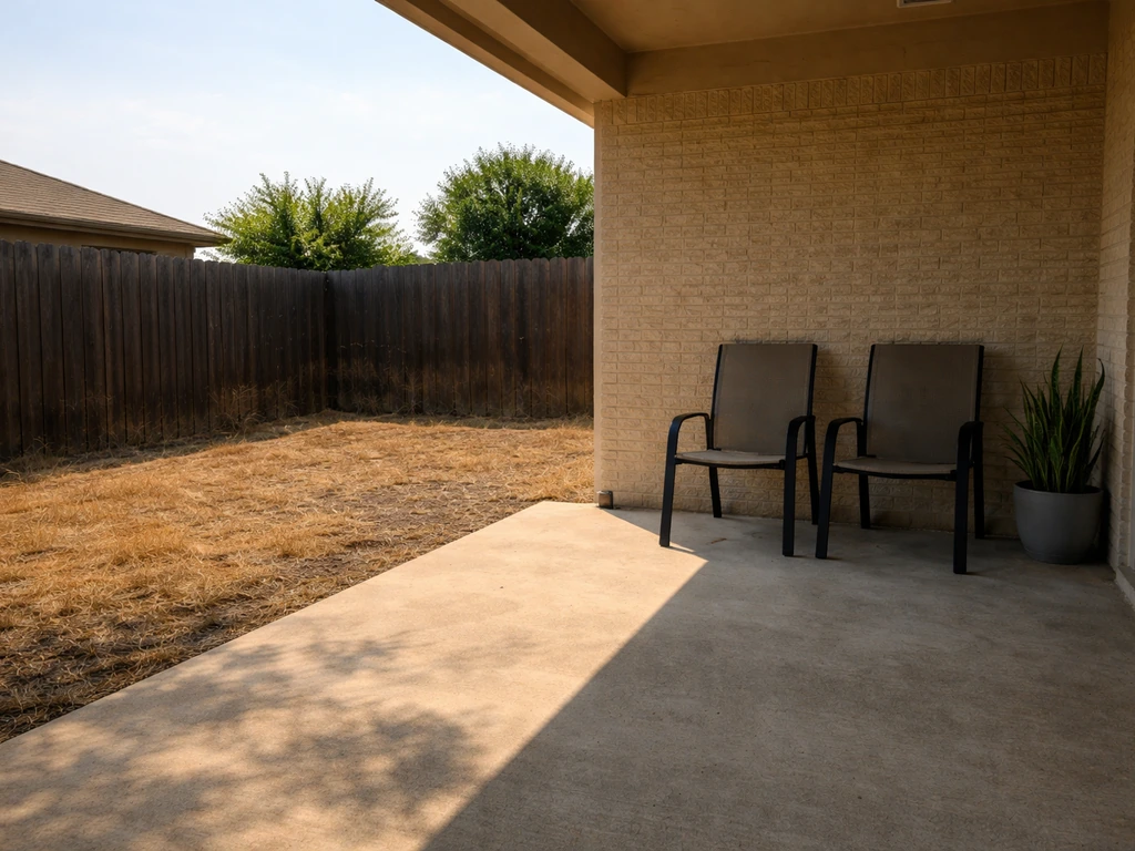 West-facing DFW patio showing intense afternoon sun on a bare surface with a shaded area for relief.